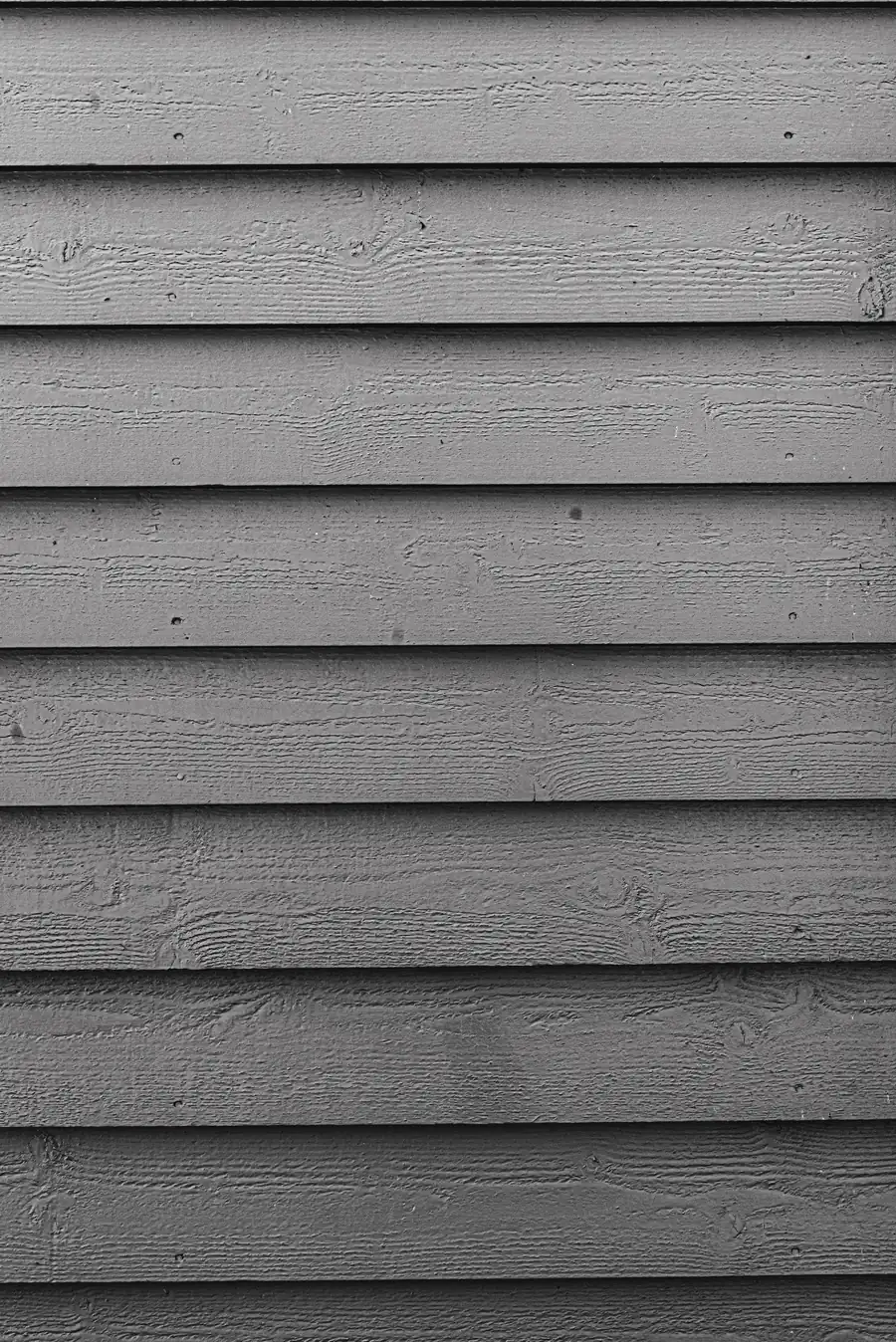 Grey weatherboard cladding close-up, horizontal timber profile