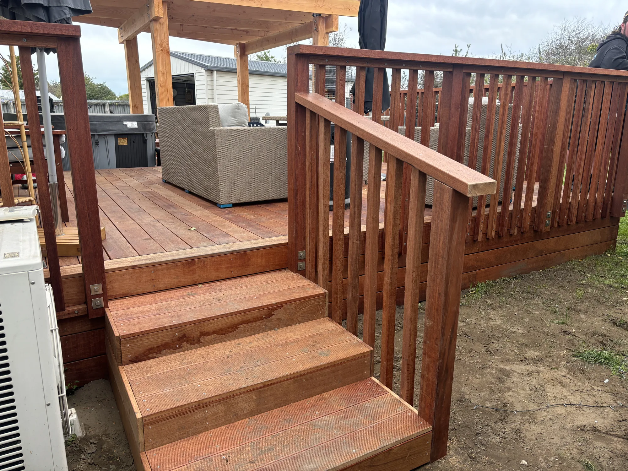 Timber deck stairs and balustrade leading to a pergola and hot tub, North Canterbury