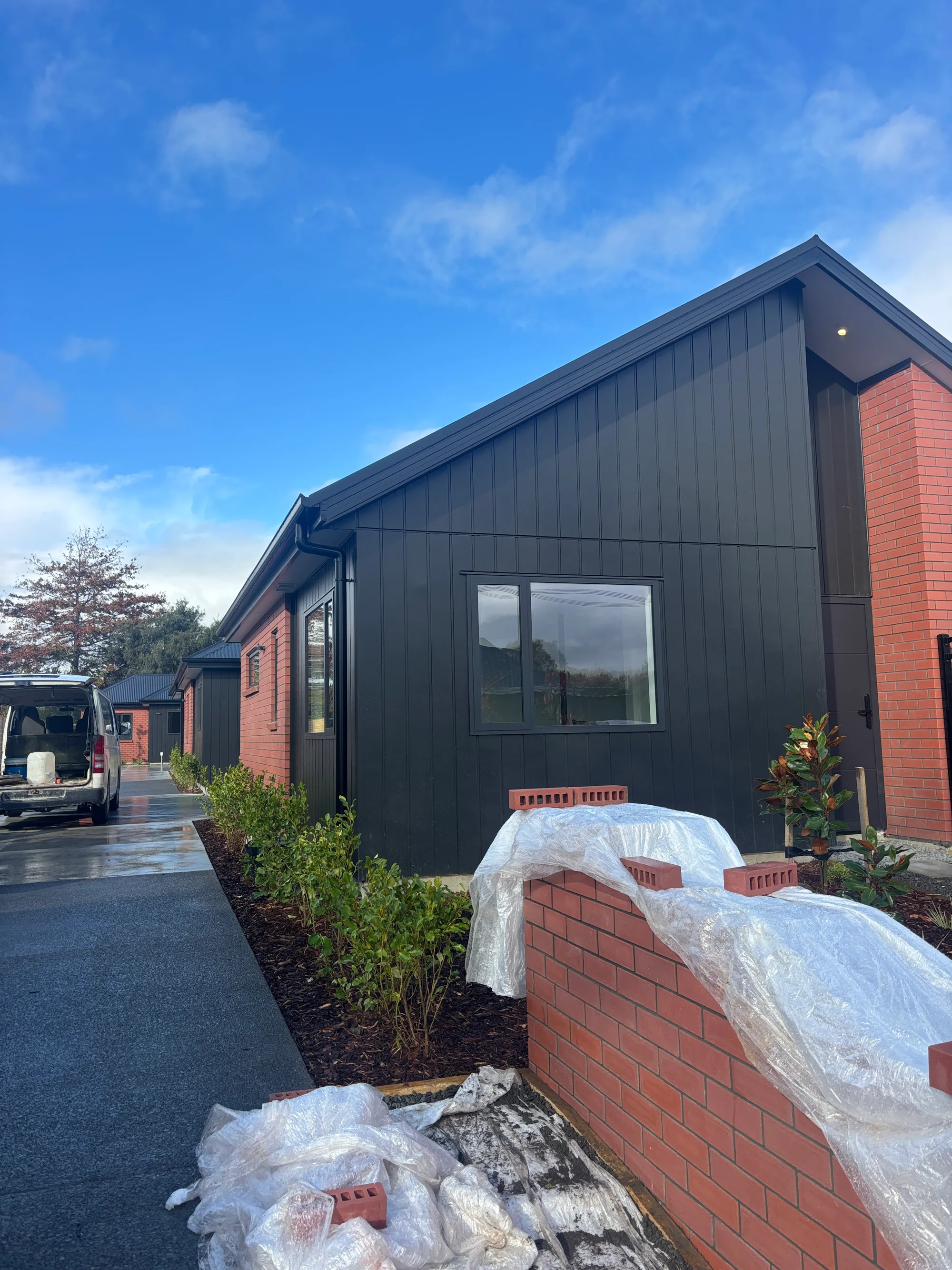 Finished black cladding and brick home in Christchurch