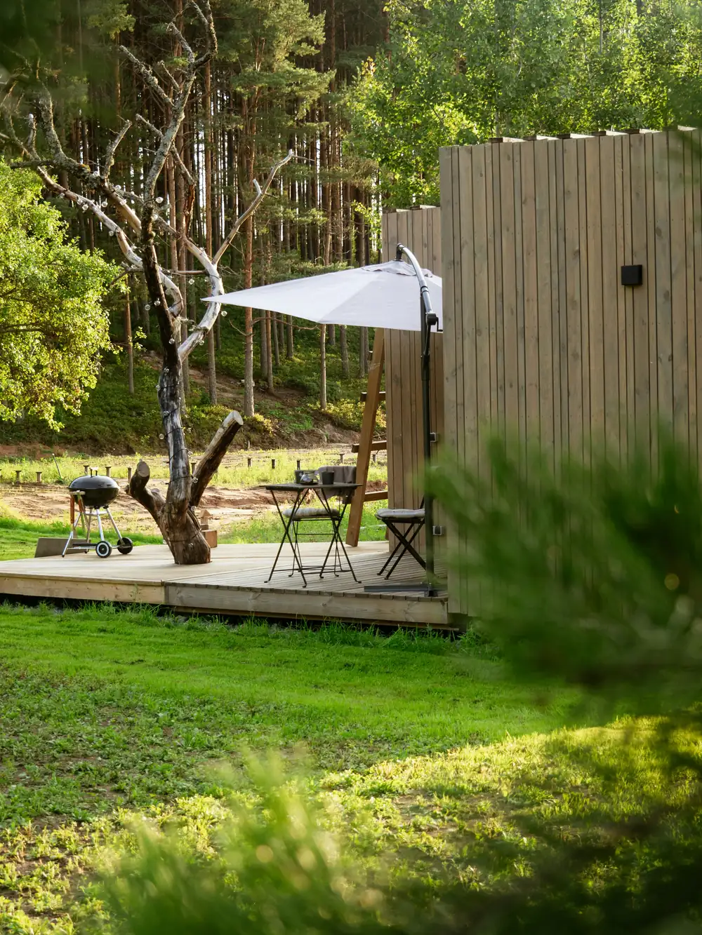 Landscaped section with deck and lawn